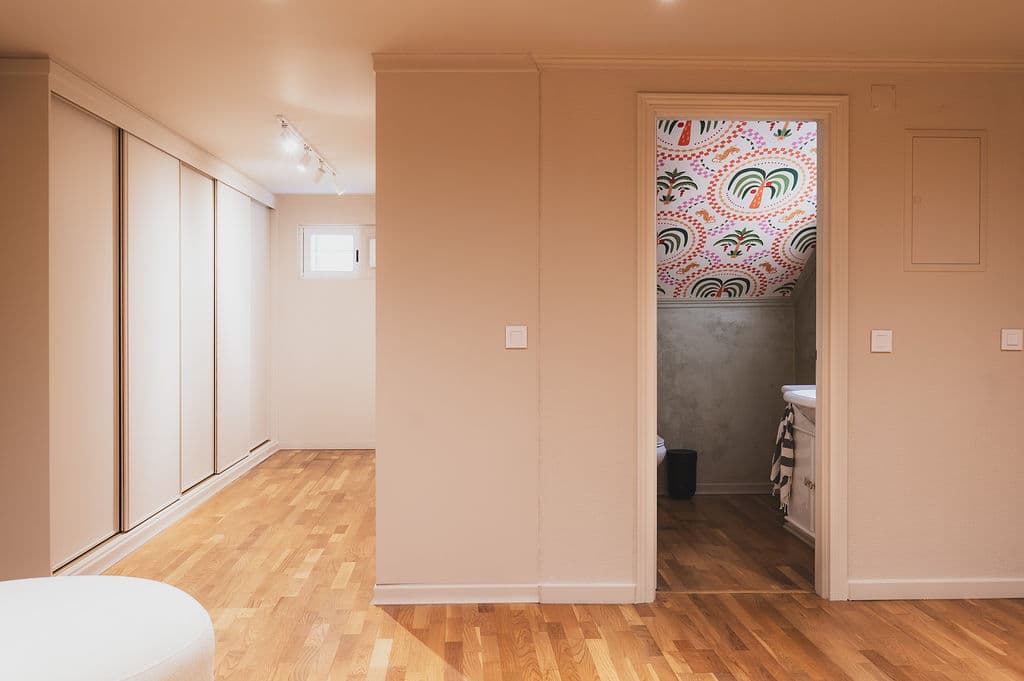The Space — corridor with storage and bathroom beyond
