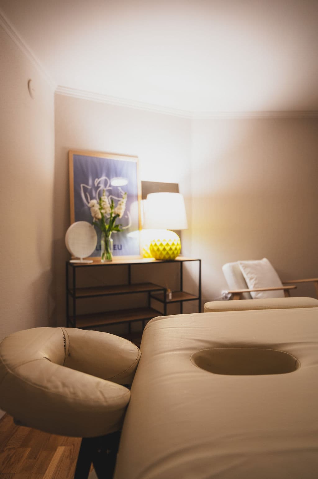Treatment Room — table with lamp and flowers