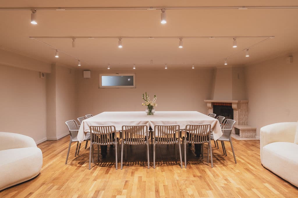 The Workshop — dining table fireplace wide